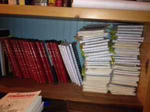 A stack of reporter's notebooks and journals.