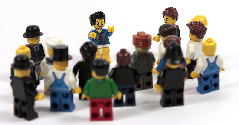 A group of Lego people stand in a group.