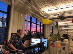 Dylan Keefe in what appears to be a DJ or audio station inside a building.