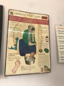 A poster hanging on a wall explaining some care practices for leprosy.