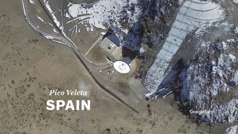A screenshot of a video. It shows an aerial image of a radiotelescope, it has the text Pico Veleta SPAIN.