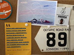 A bulletin board with a metal plaque from the 1948 Olympics in London that has the number 89 on it.