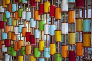 A multicolored collection of spools of thread.