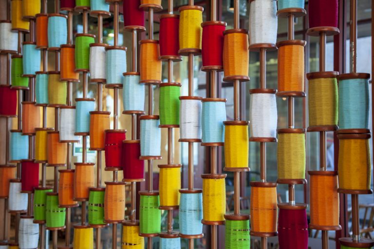 A multicolored collection of spools of thread.