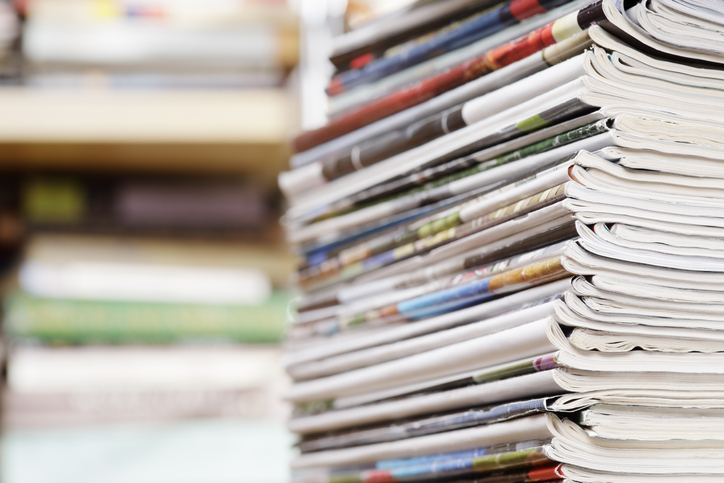 Close-up photograph of a stack of old magazines.