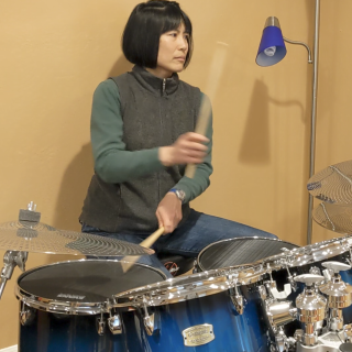 Esther playing the drums.