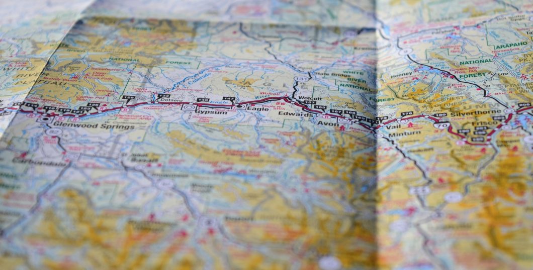 An indistinct road map with a route highlighted in purple.