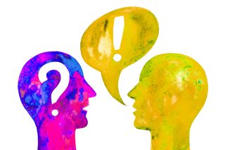 An illustration of two heads. The yellow and green one on the right has a speech bubble containing an exclamation mark coming out of it's mouth. The pink and blue head on the left has a question mark inside.