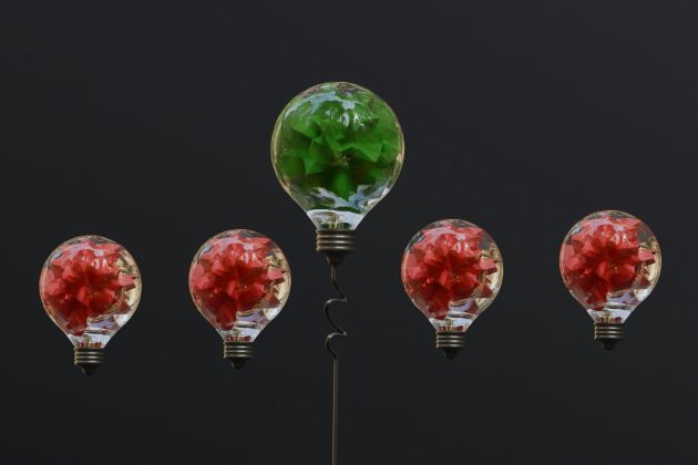 Five glass bulbs, four red and one green.